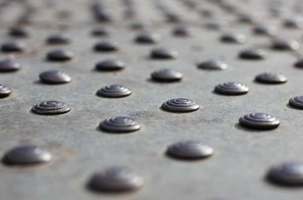 top view of an abstract shape made of metal rivets