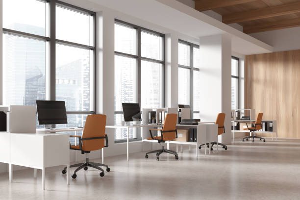 istock Workspace interior with armchairs and desks, pc monitors and shelf near window 2173864795