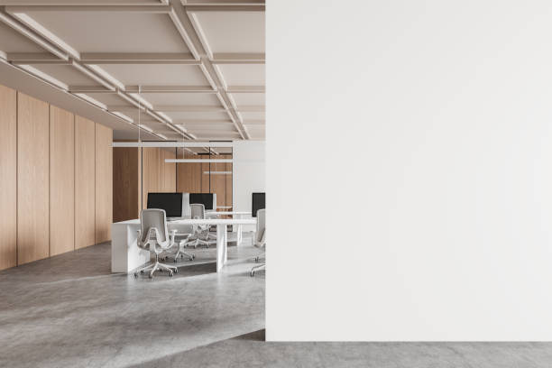 istock Modern office interior with empty white wall and desks in background. 3D Rendering 2173865407