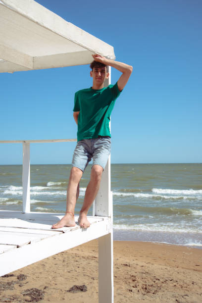 istock A young attractive man relaxes and studies by the sea. 2173868743