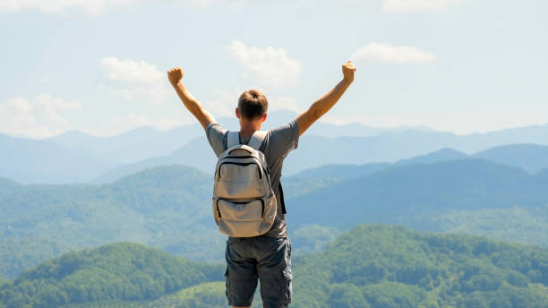 istock Male hiker celebrating climbing to the top 2173868907