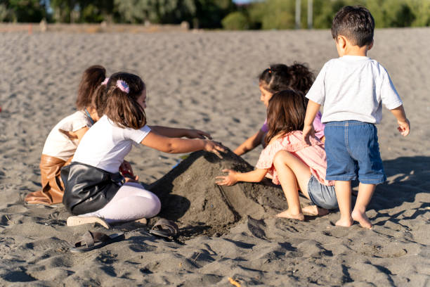 istock Children playing with sand by the sea. 2173871713