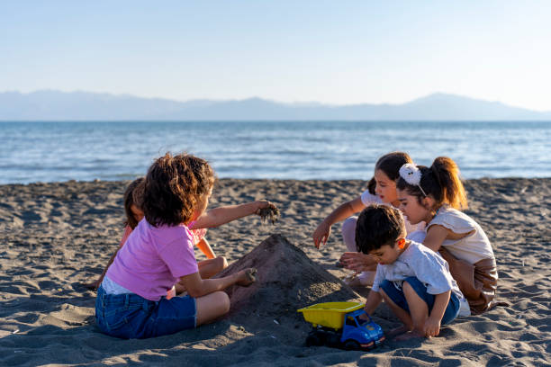 istock Children playing with sand by the sea. 2173871904