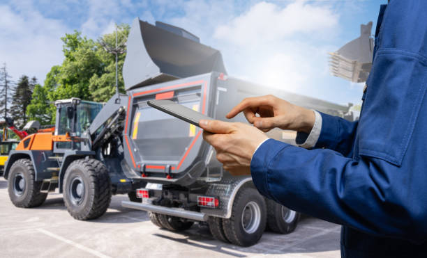 istock Hands with a digital tablet on the background of construction machines. 2173873196