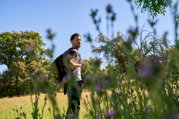 istock Young man out for hike in a forest 2173873444