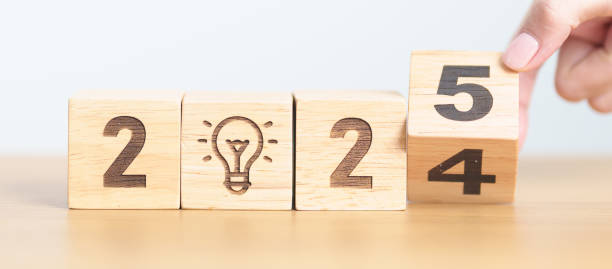 istock 2024 year change to 2025 year block with lightbulb. Business Idea, Creative, Thinking, brainstorm, Goal, Resolution, strategy, plan, Action, change and New Year start concepts 2173877375