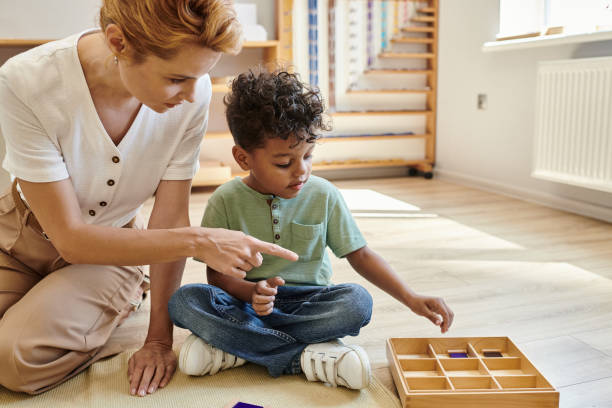istock A devoted teacher leads african american boy in engaging activities in a Montessori class 2173879653