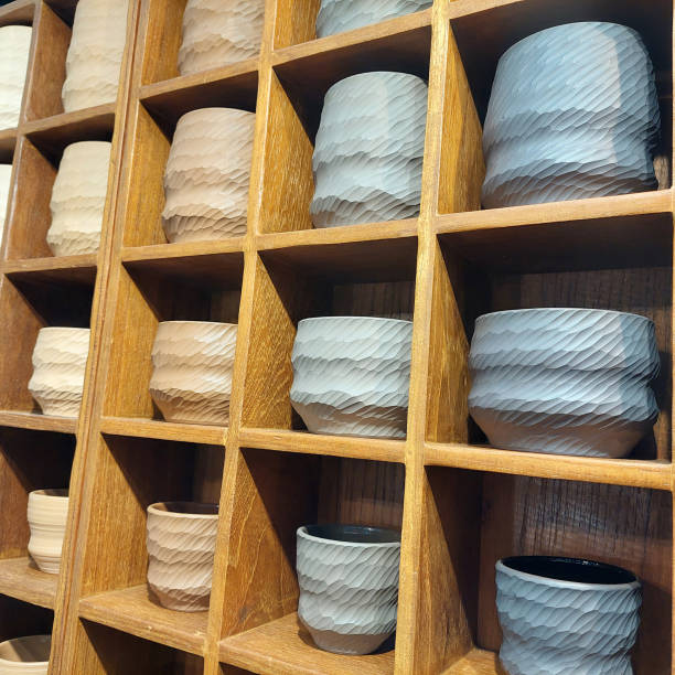 istock Handcrafted porcelain ceramic tea cups displayed on a wooden shelf 2173880487