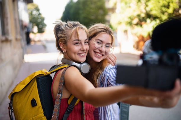 istock Young female influencers, using camera to record their experience in the city they visiting, for their travel vlog 2173883132