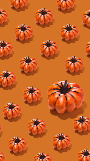 istock Pattern of orange pumpkins on orange background vertical banner 2173884873