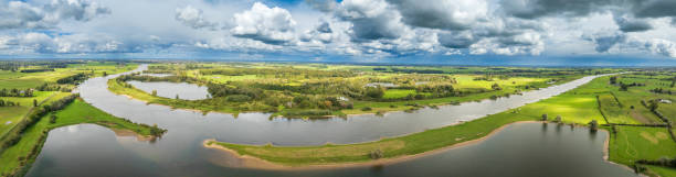 istock IJssel landscape with clouds above 2173887754