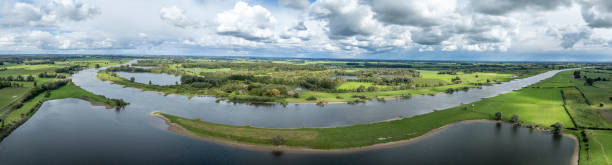 istock IJssel landscape with clouds above 2173888376