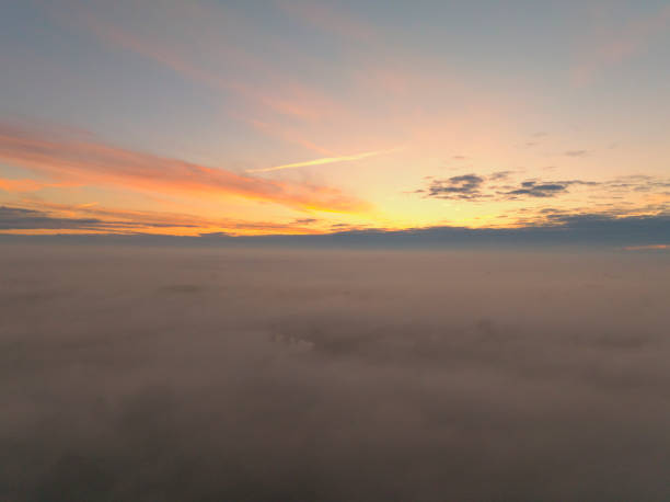 Sunrise over the clouds over the river IJssel in Gelderland during a misty autumn morning.