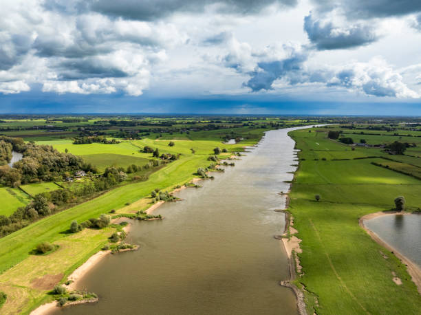 istock IJssel landscape with clouds above 2173888727