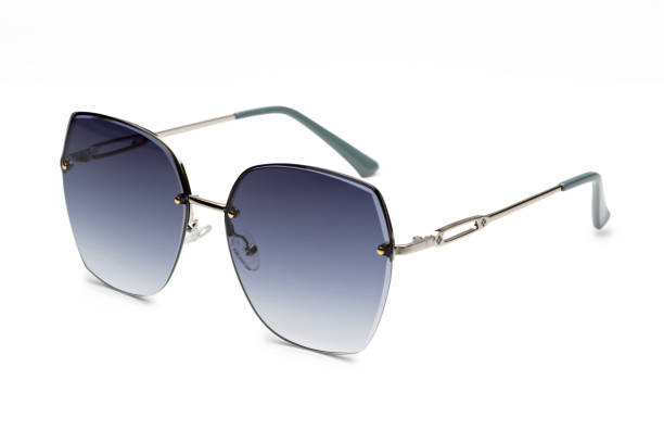 istock Modern pair of sunglasses with blue lenses and silver rims is placed on a white surface 2173889178