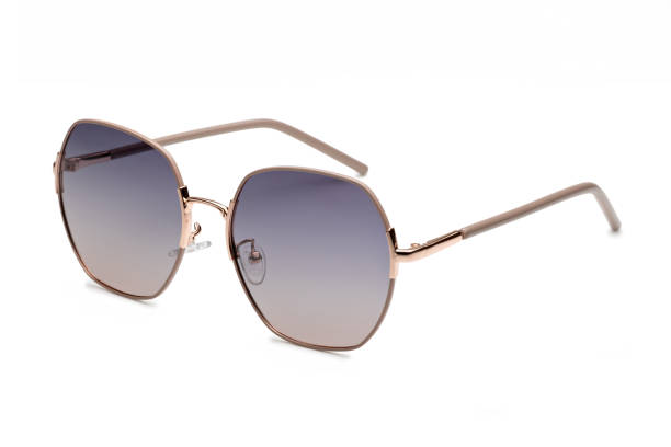 istock Rose gold sunglasses with gradient lenses and light brown temples lying on a white surface 2173889200