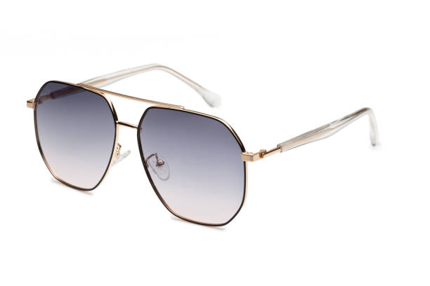 istock Stylish sunglasses with thin gold rims and gradient lenses lying on a white background 2173889205