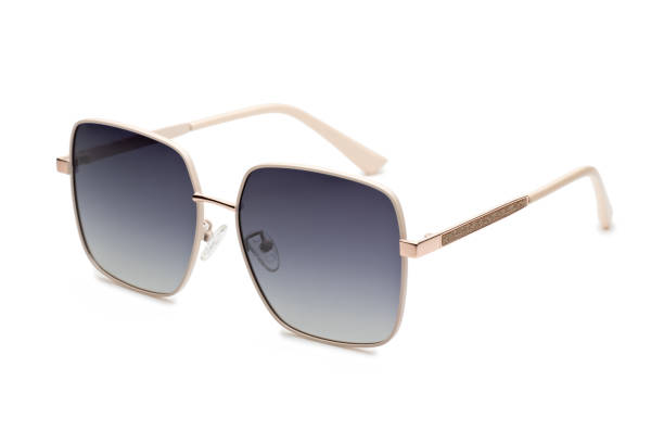Modern sunglasses with thin temples and gradient lenses lying on white background