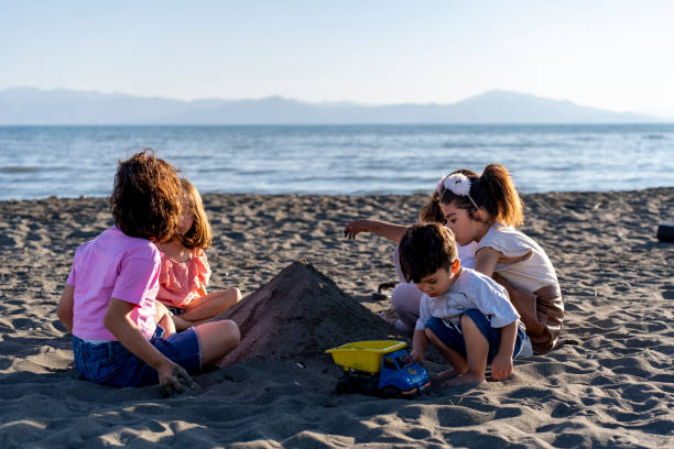 istock Children playing with sand by the sea. 2173889318