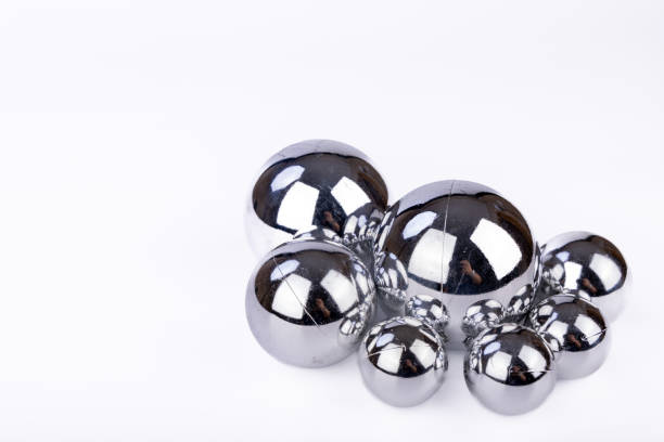 istock Shimmering silver Christmas balls of different sizes displayed on a white background, capturing a classic festive décor style 2173892959