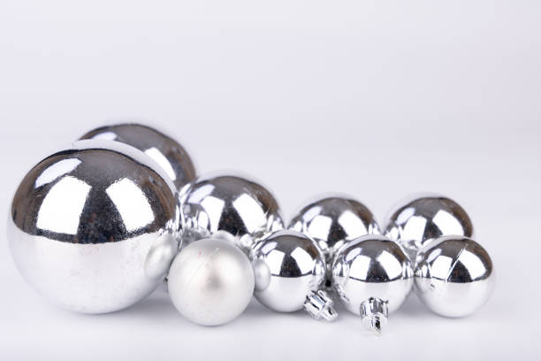 istock Shiny silver Christmas ornaments in various sizes on a white background, perfect for minimalist festive decoration 2173893025