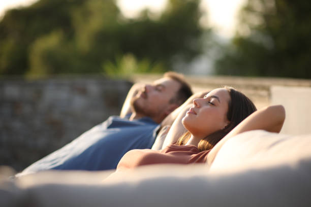 Couple resting and relaxing in a couch in a terrace