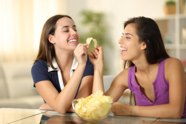 istock Happy friends eating toasting with potato chips 2173899442