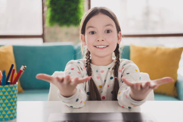 istock Portrait of charming little girl communicate web camera video call wear pullover modern interior flat indoors 2173899622