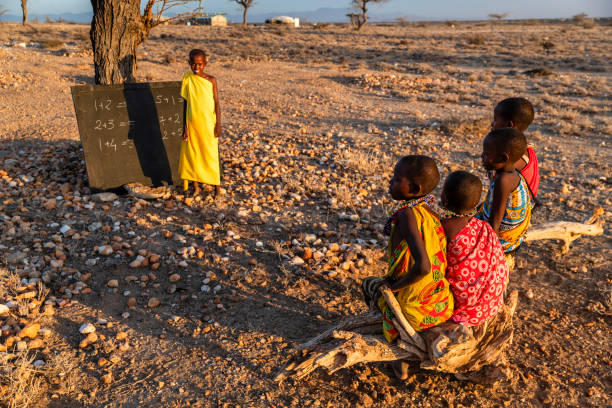 African children  from Samburu tribe during math class under the acacia tree in remote village, Kenya, East Africa. Samburu tribe is one of the biggest tribes of north-central Kenya, and they are related to the Maasai.