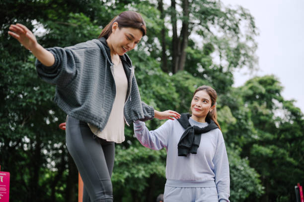 istock Two Asian women doing physical therapy exercises at public park. 2173903779