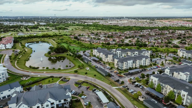 istock Mixed-use development area with pond water fountain, apartment complex, residential neighborhood, industrial zoning warehouses in fast growing area Pflugerville northeast of downtown Austin, TX 2173904907