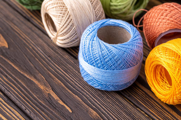 Multicolor yarn for knitting, knitting needles and scissors. Home storage concept and hobby.Raffia is an organic, ecological, wood fiber that is easy to crochet.