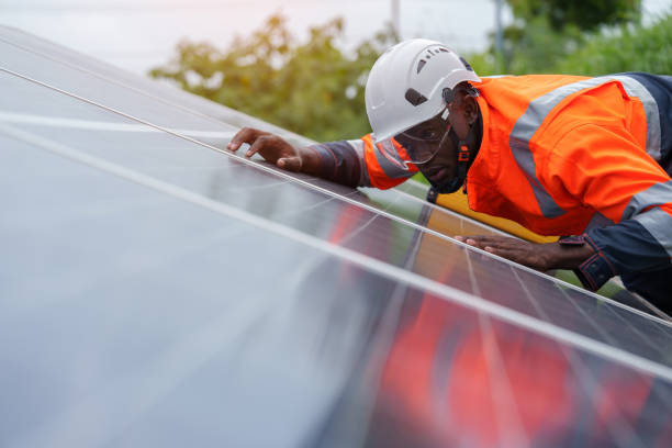 istock Solar engineers work at night using iPads outside power stations and wind turbines to protect inspectors 2173906706
