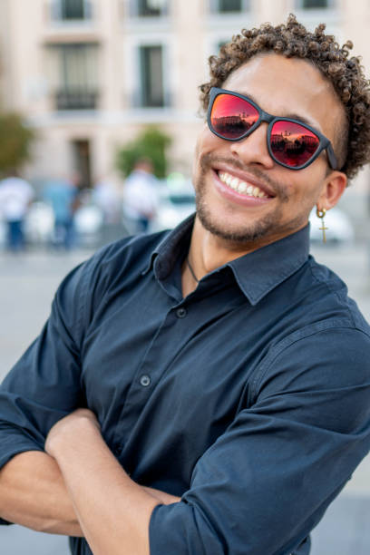 istock Man in Sunglasses with Arms Crossed Smiling Confidently 2173907075