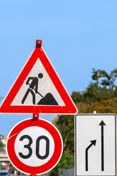 istock Traffic signs constructions site and speed limitation against clear sky 2173908239