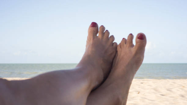 istock Human feet sunbathing on the beach 2173908843