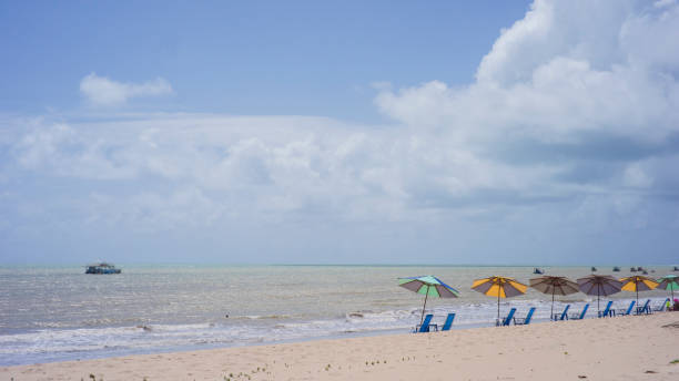 beach scene, waterfront with chairs and umbrella
