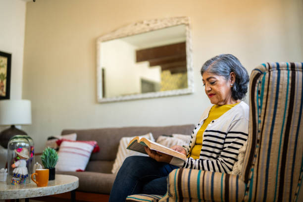 istock Senior woman reading book at home 2173909964