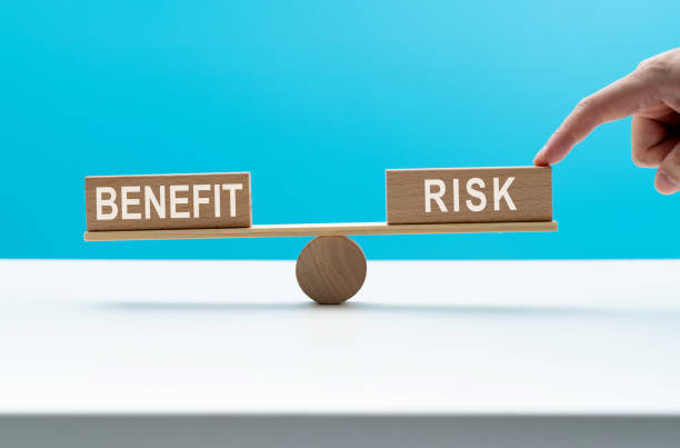 istock Wooden seesaw with word risk and benefit 2173910055
