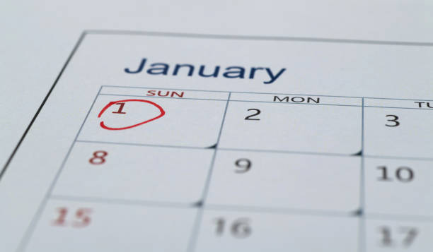 Desk calendar on wood background