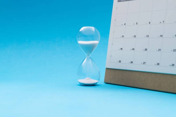 istock Calendar and hourglass on blue background 2173910282