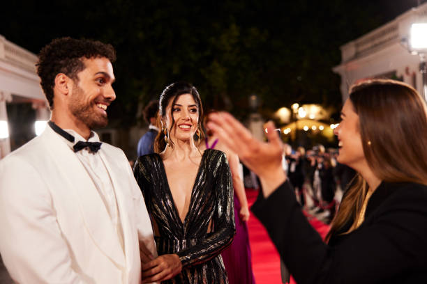 istock Vlogger interviews actors at the premier event using a smartphone video camera. 2173911980