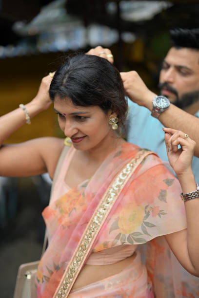 istock Husband gently placing jasmine flower on wife's hair 2173914323