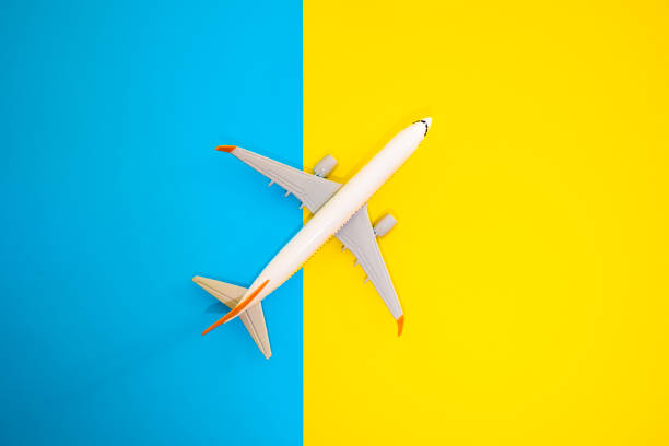 istock airplane on blue and yellow background 2173915780