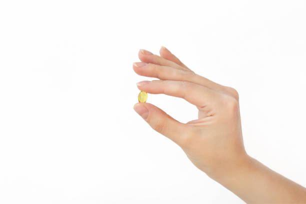 istock capsule in female hand on white background 2173916507