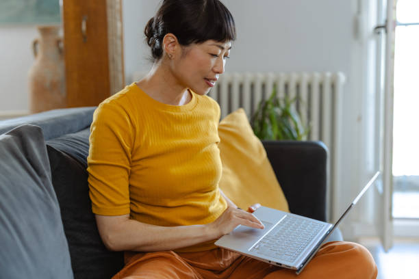 istock Japanese woman working on laptop at home. Relaxing and using technology 2173917684