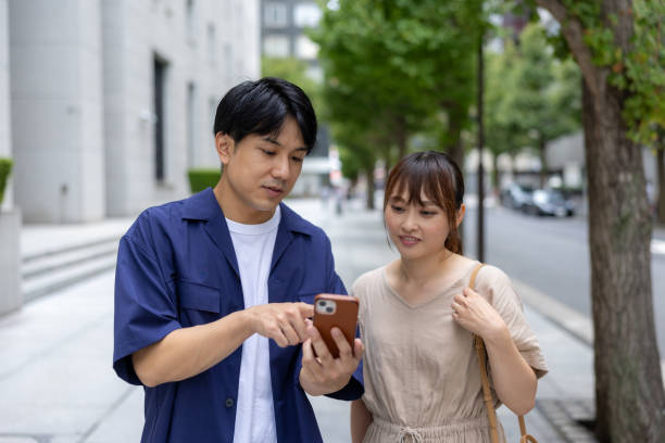 istock Couple using smart phone in city 2173920387