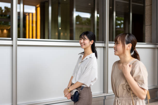 istock Female friends walking in city 2173920593