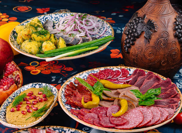 istock Table is set with plates of meat, fish, and sauce 2173921379