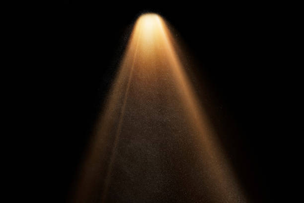 istock orange spotlight on stage or gods rays isolated on black background 2173923324